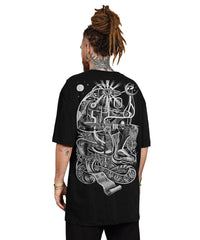 Person wearing a black t-shirt with a detailed white design on the back, standing against a white background.