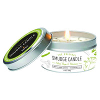 White Sage & Patchouli Soy Smudge Travel Tin Candle burning in a silver metal tin