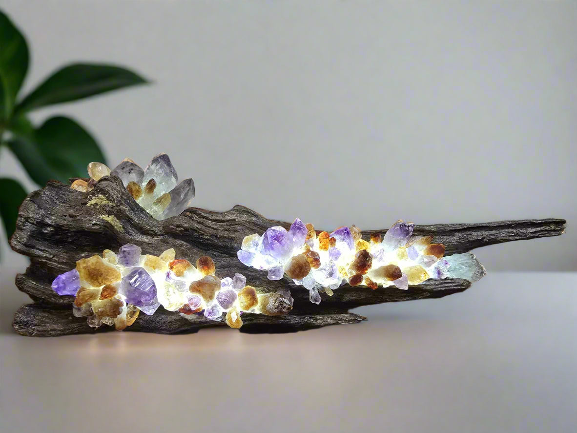 a wooden lamp with natural crystal set wwith light behind them 
